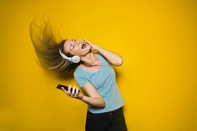 woman listening to music to manage stress